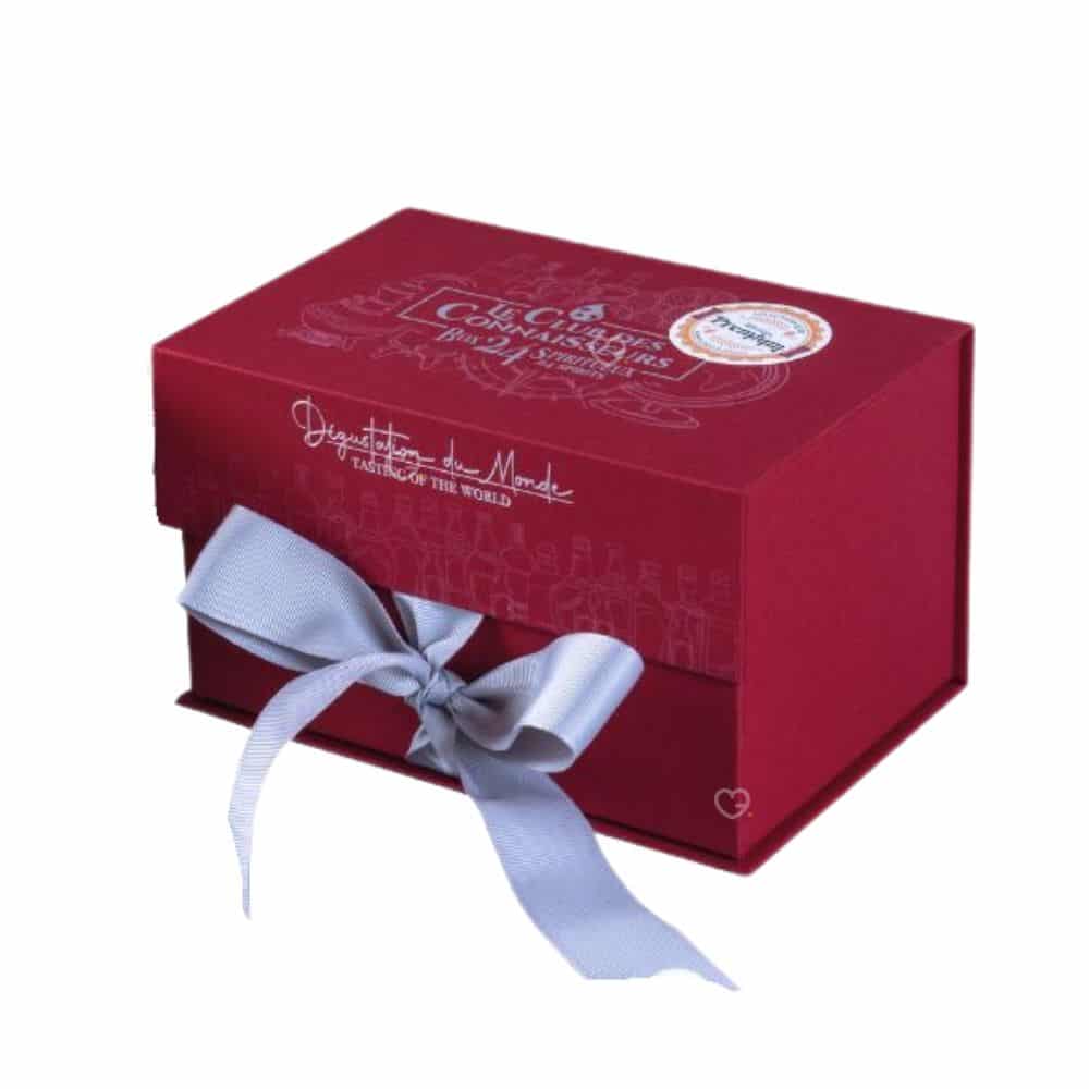 coffret rouge avec noeud calendrier de l'avent le club des connaisseurs 2024 contenant 24 rhums de pays et saveurs différentes