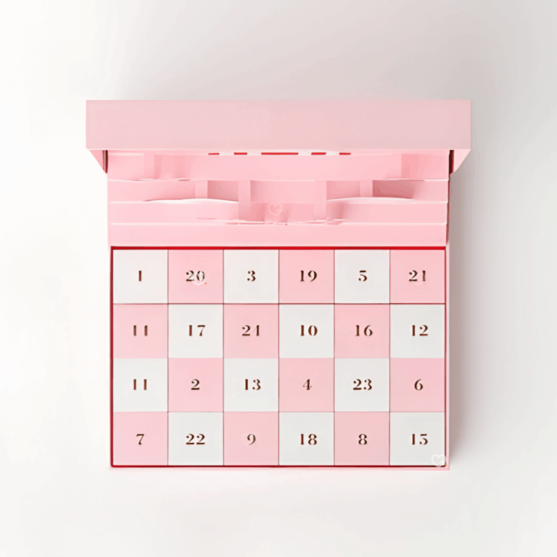 Coffret chocolat illustré Calendrier de l’Avent Fauchon 2025 contenant 24 chocolats et confiseries artisanales, packaging rosé pop-up luxueux et design pour gourmand