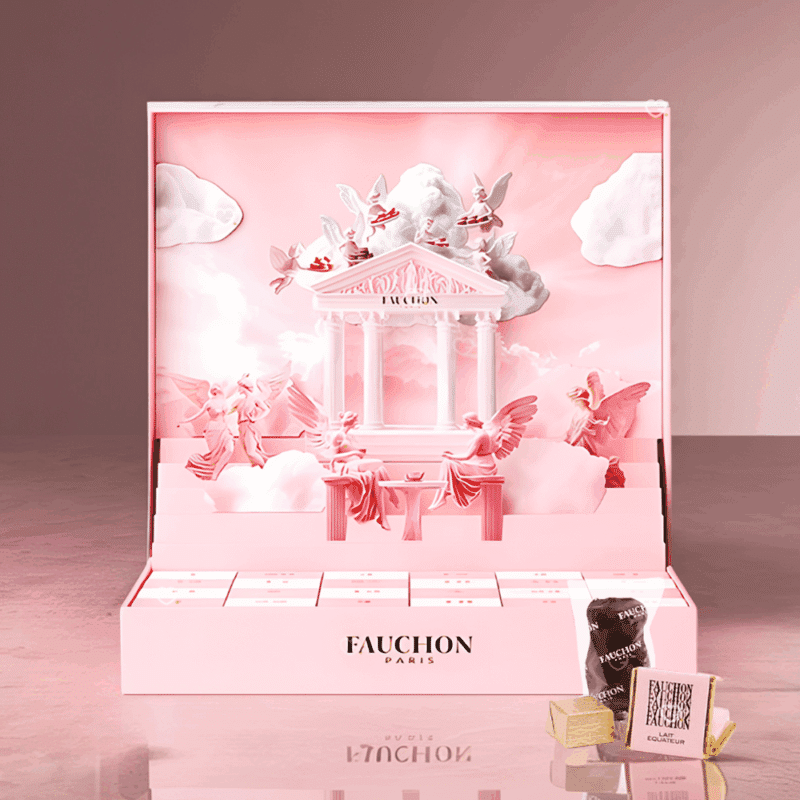 Coffret chocolat illustré Calendrier de l’Avent Fauchon 2025 contenant 24 chocolats et confiseries artisanales, packaging rosé pop-up luxueux et design pour gourmand