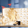 Calendrier de l’Avent Guerlain 2025 en coffret luxueux en forme de livre renfermant 25 produits beauté iconiques, parfums, soins, maquillage et bougie idéal cadeau femme luxe.