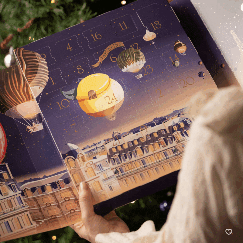 Calendrier de l’Avent Angelina 2025 raffiné, révélant 24 douceurs chocolatées et pralinées pour gourmets amoureux du luxe parisien.