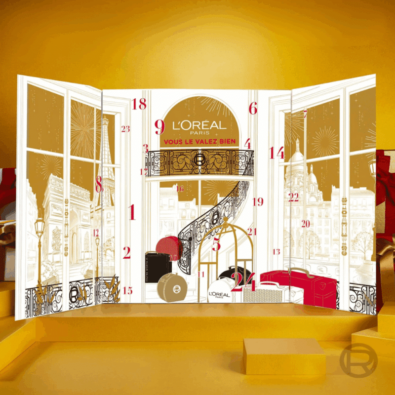 Calendrier de l'Avent L'Oréal Paris 2025 contenant 24 produits de beauté en taille réelle pour le maquillage et les soins du visage présenté dans un coffret élégant doré et blanc