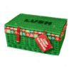 Calendrier de l'Avent Lush 2026, panier en osier vert fermé avec sangles cuir rouge
