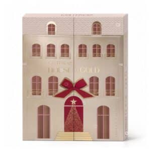 Calendrier de l'Avent Catrice House Of Gold 2026, boite fermee en forme de maison doree avec 24 portes et noeud rouge